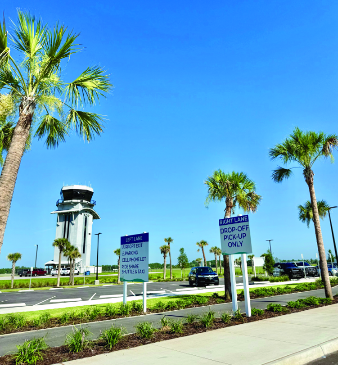 airport with signage and palm trees