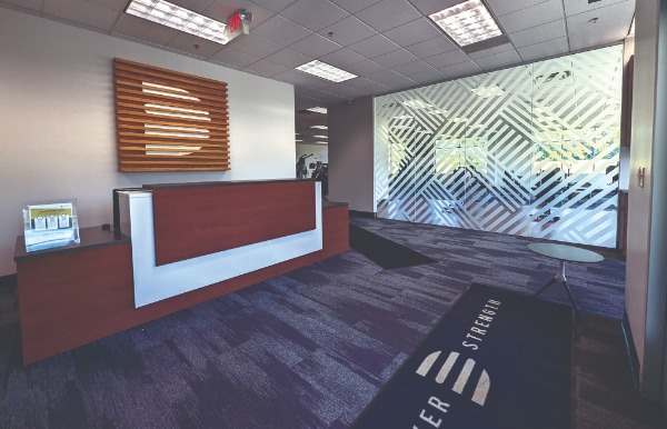 a commercial office building with a wood paneling wall sign