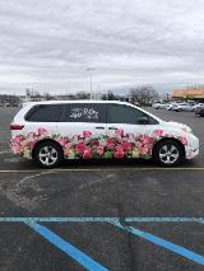 White car with flower car wrap Photo