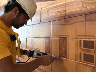 Man working on the wall graphic Photo