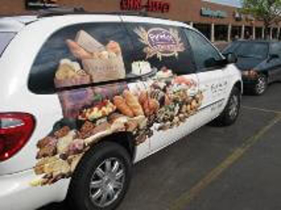 White car with food graphics Photo