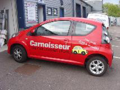 Red car with vehicle graphics Photo