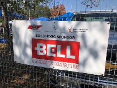 Bell signage on fence Photo