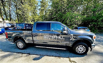 Black truck with vehicle graphics Photo