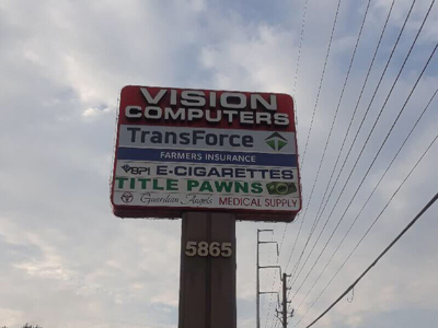 Different business names on the pylon pole Photo