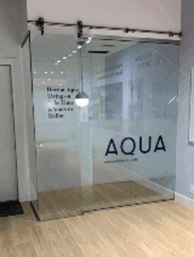Aqua sign on the glass door Photo
