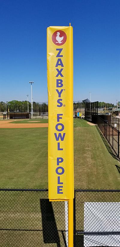 Yellow Pole on the side of the field Photo