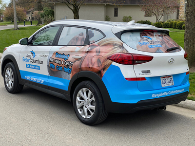 A car wrapped with graphics Photo