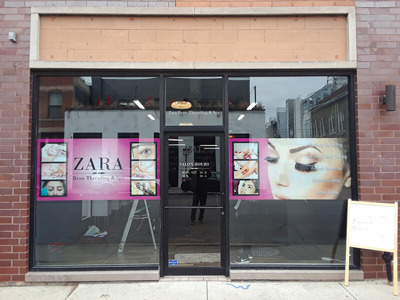 Zara brow salon window with graphics Photo