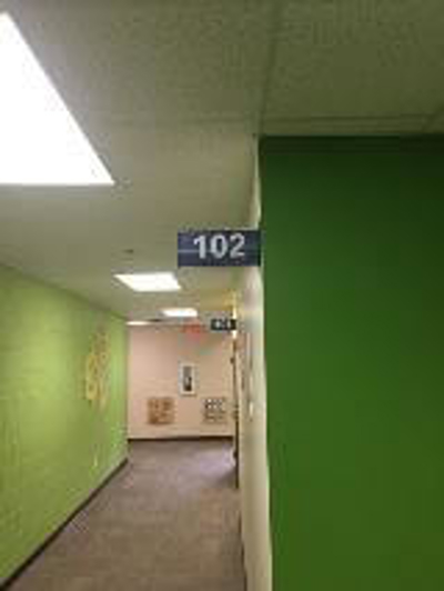 102 sign along the hallway Photo