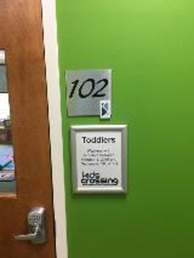 room 102 sign on the wall Photo