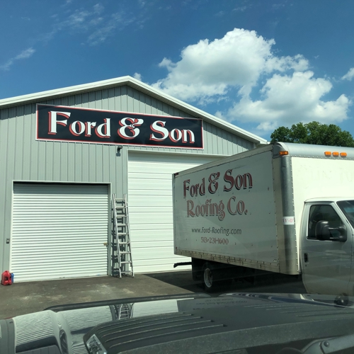 Ford & Son signage on the  white warehouse with truck in front