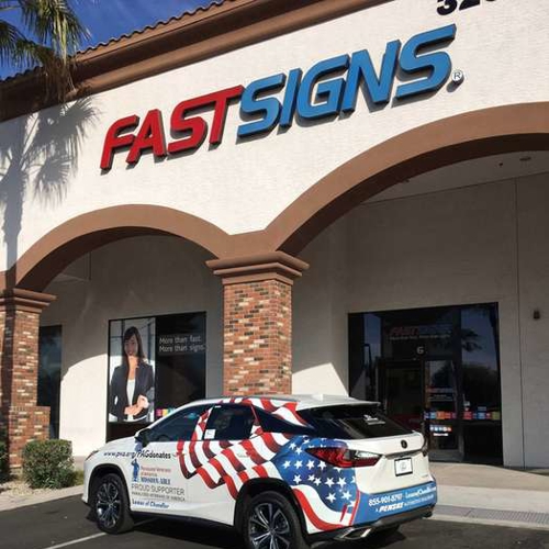 White car in front of fastsigns building