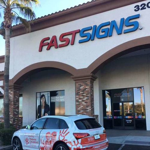 White car in front of fastsigns building