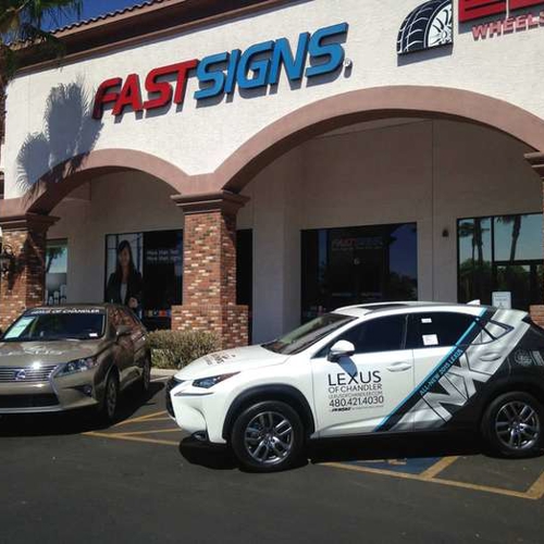 two cars in front of fastsigns building