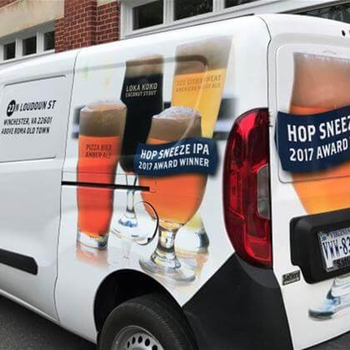 White van with custom drinks graphics