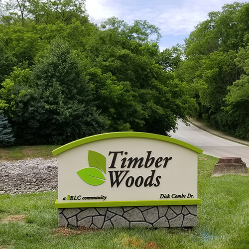 Green and white timber woods monument signage