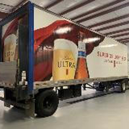 Superior light beer truck wrapped with graphics and parked on a garage