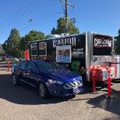 Carnivorum truck on the drive-tru with blue car