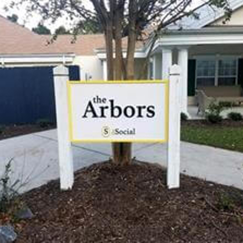 The social arbors signage in front of the tree