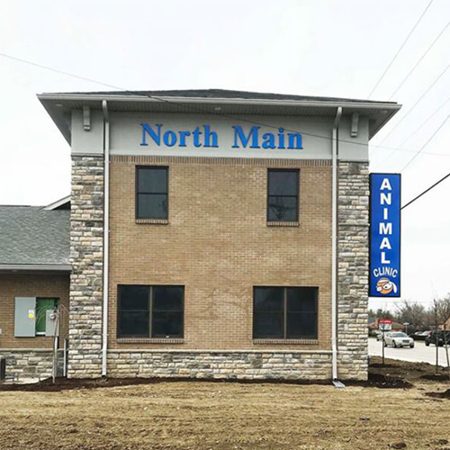 North Main Animal Clinic signage on the building  with electrical post on the side