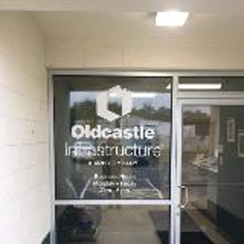 Oldcastle infrastructure sign on the front door of the building