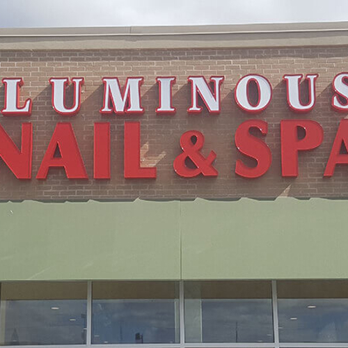Luminous Nail and spa signage on the building