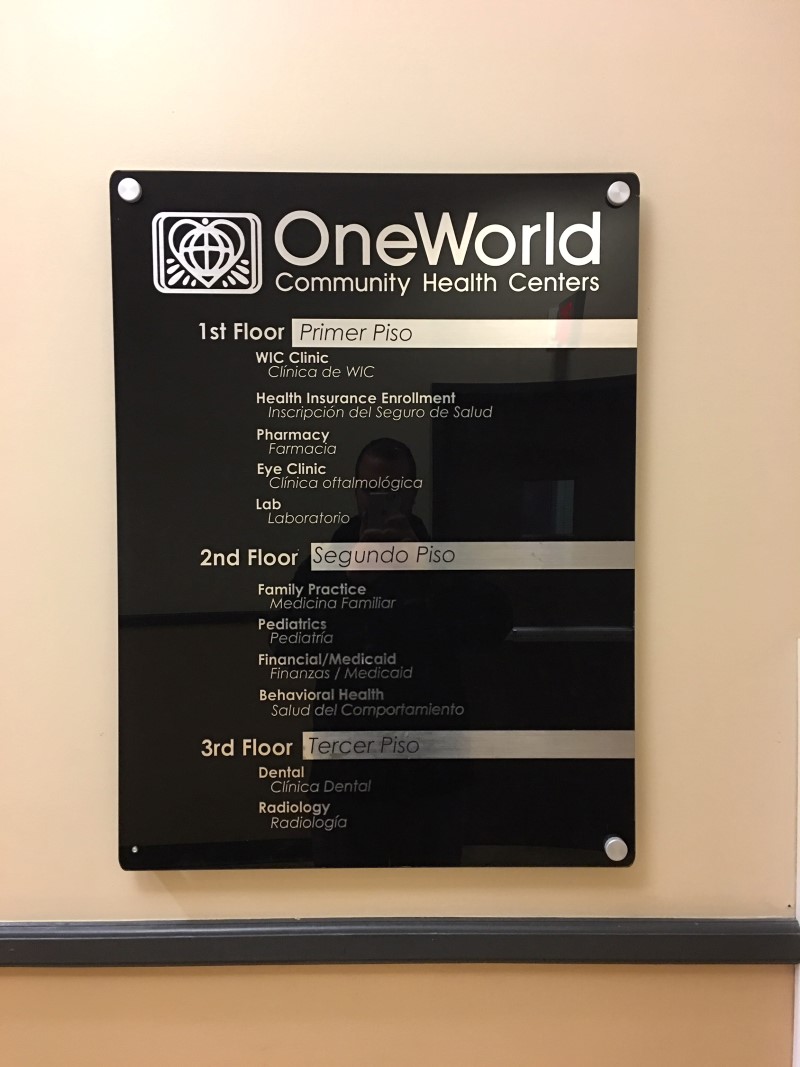One World Community Health Glass Wall Sign