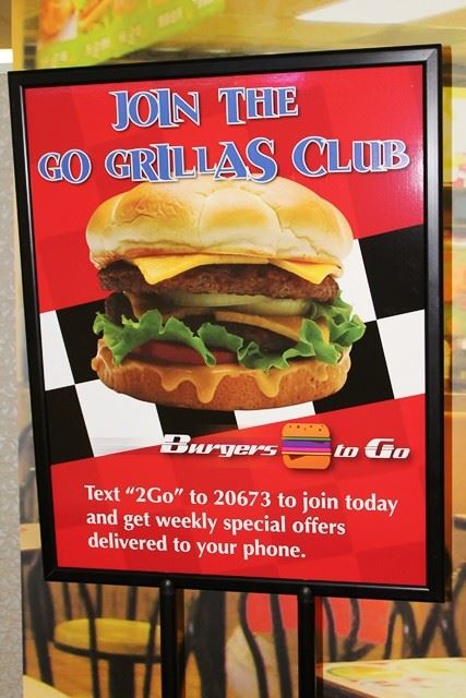 A restaurant sign asks customers to sign up for text marketing updates