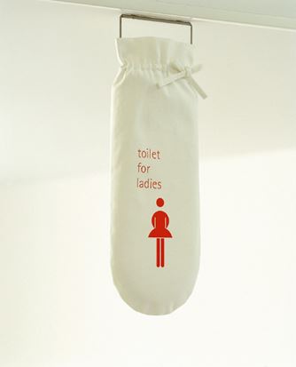 A cloth sign hangs indicating the women's restroom