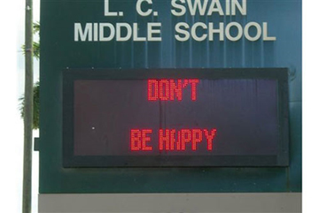 A school's digital sign says "Don't Be Happy"