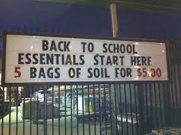 A store's back to school sign also advertises a sale on soil