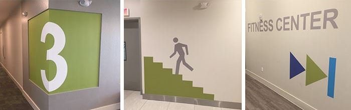 A collection of branded wayfinding signs and wall graphics