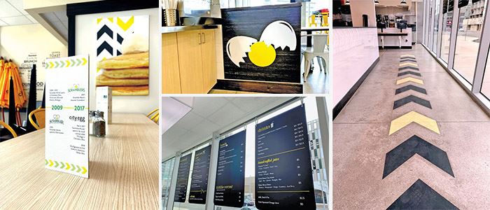 Brand-consistent floor graphics, hanging signs, and stand up signs