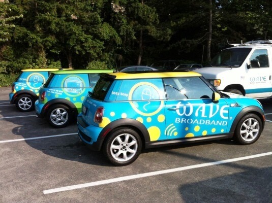 three cars wrapped with graphic for wave broadband
