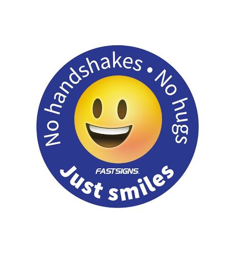 A decal with a smiling face says "No handshakes No hugs Just smiles"