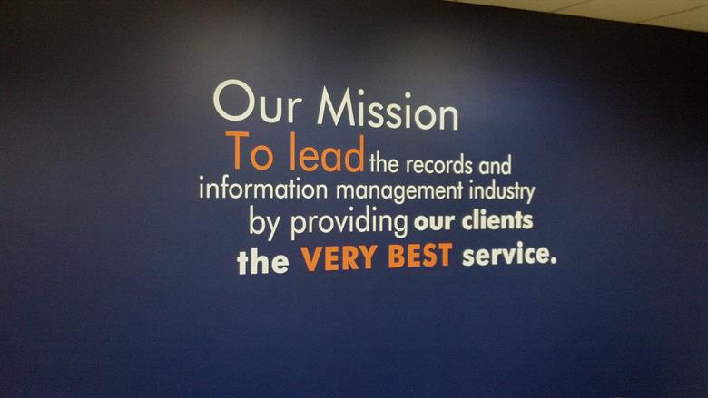 A company's mission is written on a wall