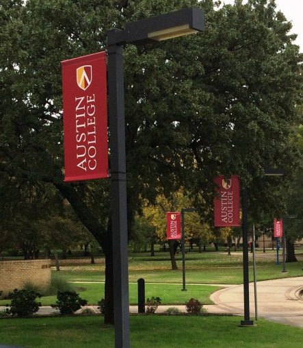 Austin College uses flags hanging from streetlights
