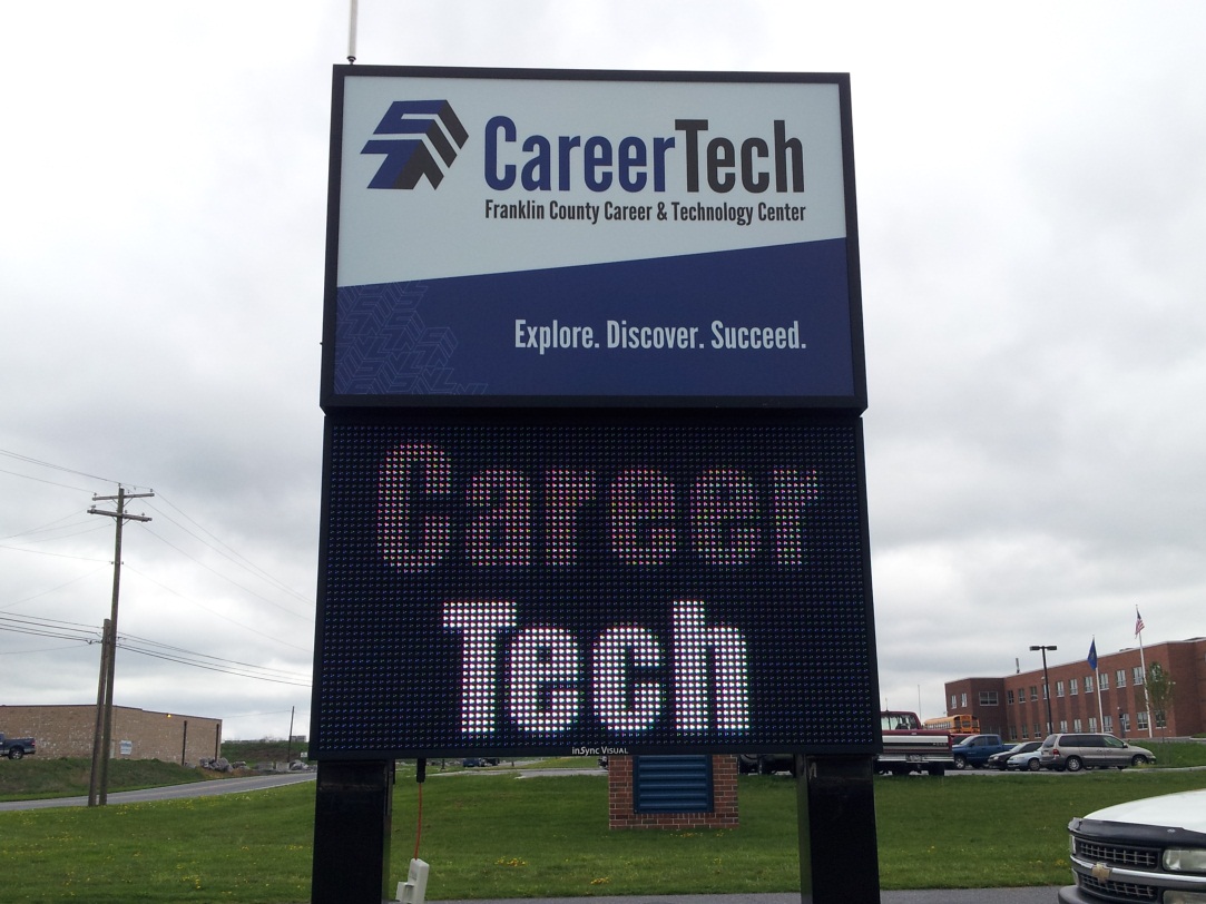 A career technical school uses a digital sign to provide information to people passing by