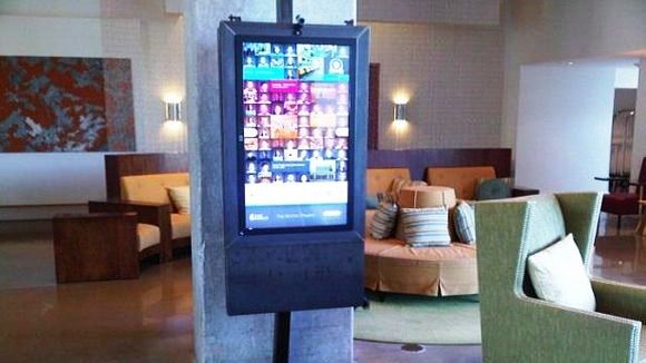 An interactive digital screen invites guests to engage with it