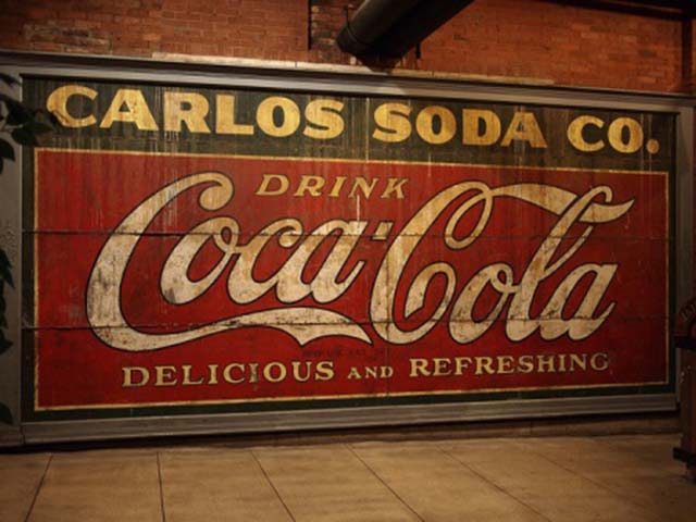 A hand painted Coca Cola sign on the side of a building