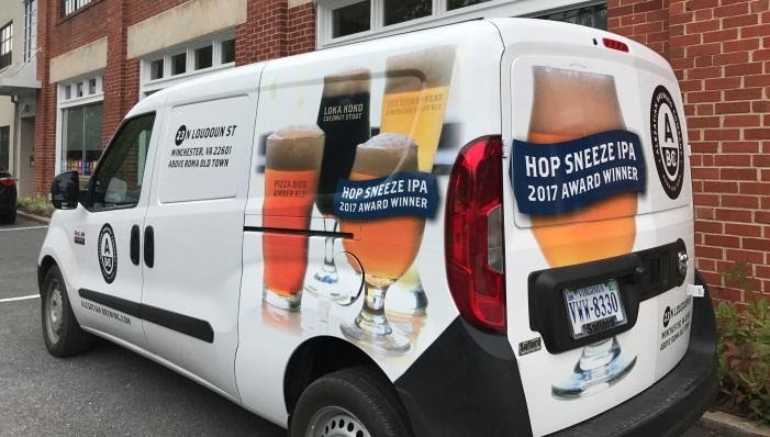 A van has custom graphics advertising beer on it