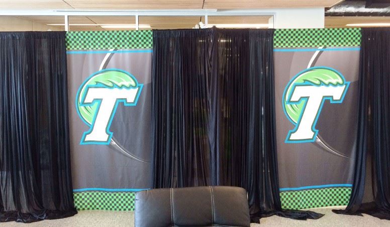 The Tulane athletics welcome area has fabric curtains over the school logo