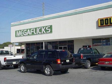 The MegaFlicks logo on a store front