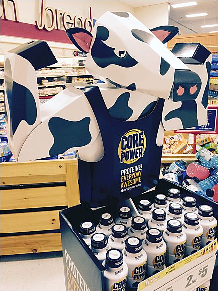 A cow in an apron flexing its muscles advertises CORE POWER Protein milk