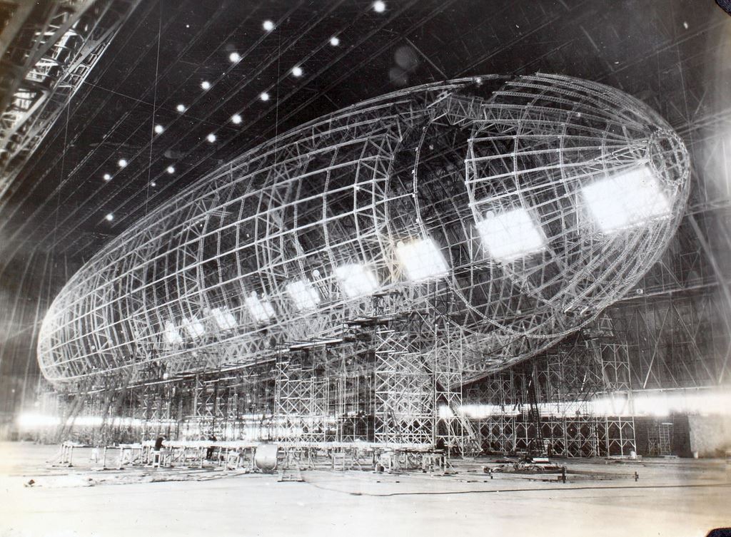 A black and white image of a GoodYear Blimp being built