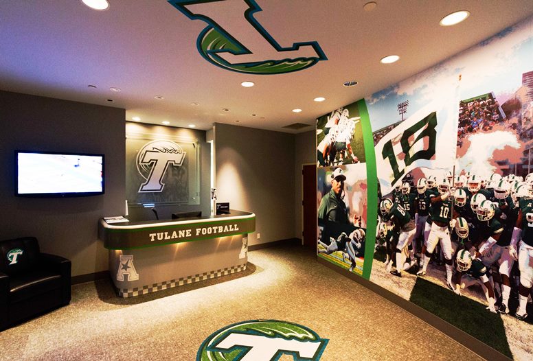 a Tulane football themed room with a wall mural, logo on floor and ceiling and on the wall