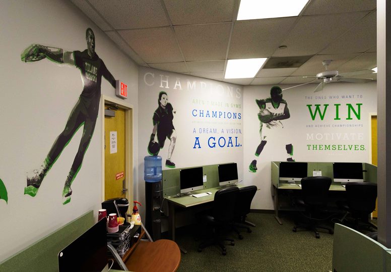 Motivational quotes and cut outs of athletes decorate walls in a room