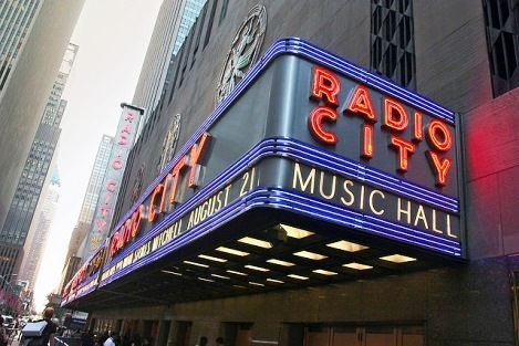 The Radio City Music Hall Electronic Marquee stretches the entire city block, and is a common tourist attraction in New York.
