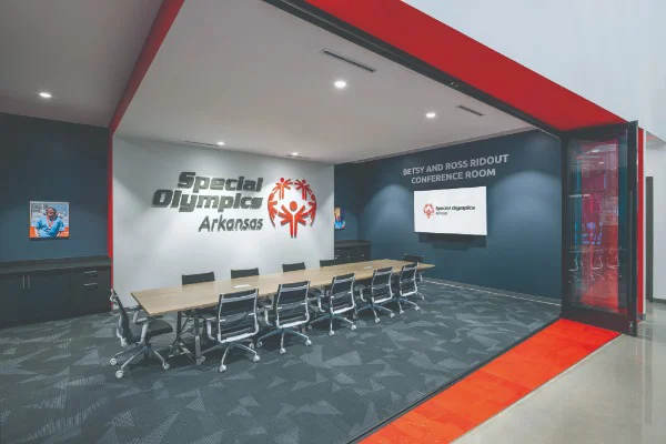 a large conference room with special olympics signage